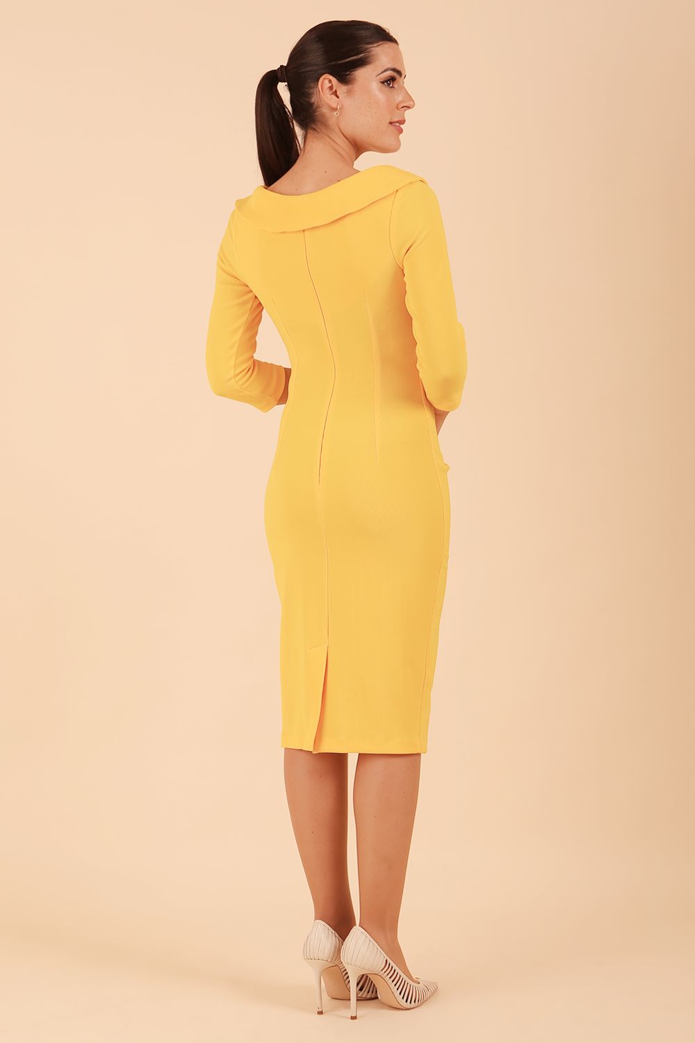 Model wearing diva catwalk Monique 3/4 Sleeve Pencil Dress with Overlapping Folded Round Neckline and 3/4 sleeves and knee length in Sunshine Yellow back