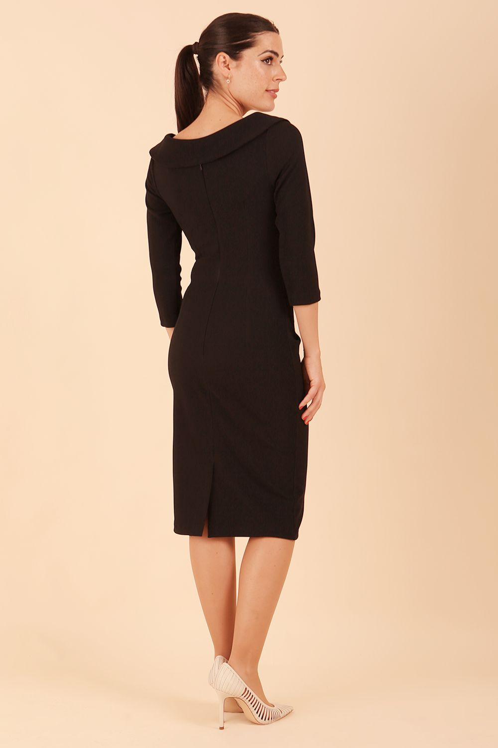 Model wearing diva catwalk Monique 3/4 Sleeve Pencil Dress with Overlapping Folded Round Neckline and 3/4 sleeves and knee length in Black back