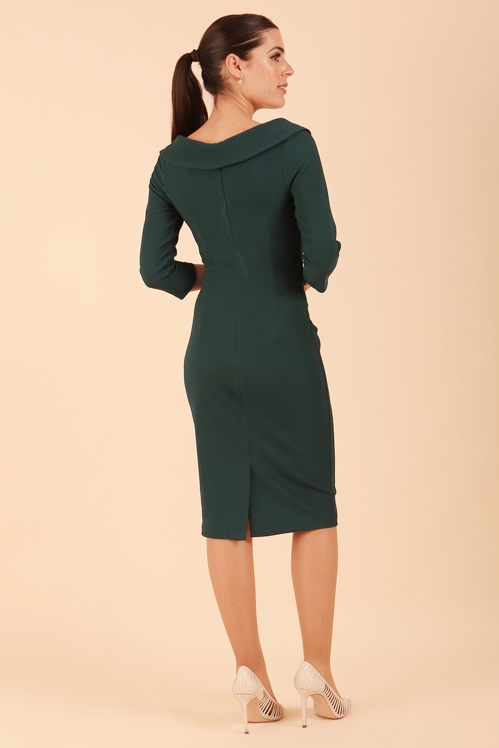 Model wearing diva catwalk Monique 3/4 Sleeve Pencil Dress with Overlapping Folded Round Neckline and 3/4 sleeves and knee length in Green Gables back