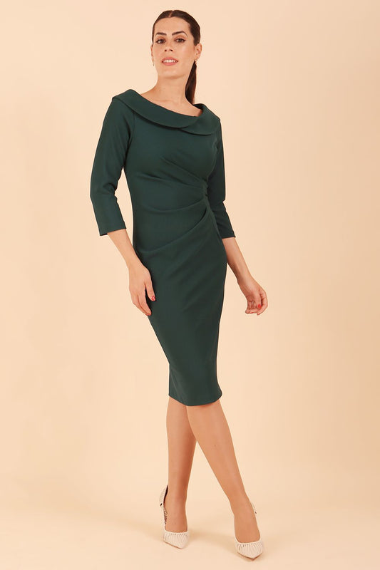 Model wearing diva catwalk Monique 3/4 Sleeve Pencil Dress with Overlapping Folded Round Neckline and 3/4 sleeves and knee length in Green Gables front