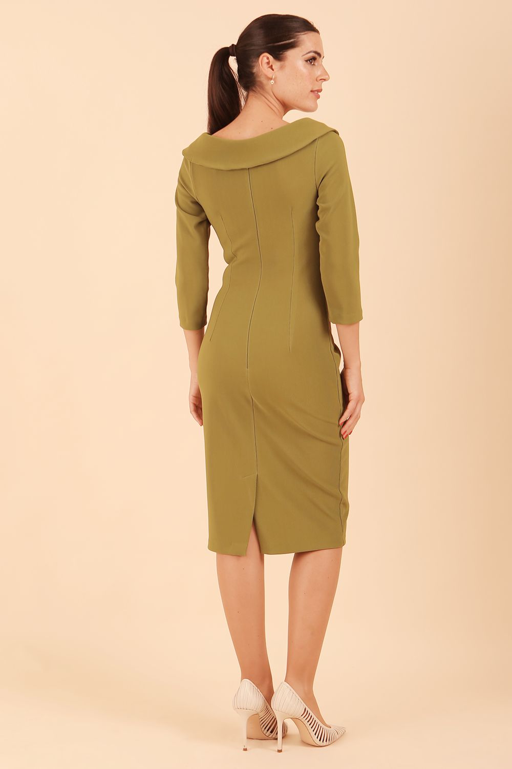 Model wearing diva catwalk Monique 3/4 Sleeve Pencil Dress with Overlapping Folded Round Neckline and 3/4 sleeves and knee length in Jasmine Green back