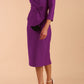 Model wearing diva catwalk Seed Elsye 3/4 Sleeve Knee Length Pencil Dress with Fold over bateau collar neckline with contrast piping and Bow feature on the left side of the bodice in Amethyst Purple colour front side