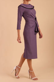 Model wearing diva catwalk Seed  Elsye 3/4 Sleeve Knee Length Pencil Dress with Fold over bateau collar neckline with contrast piping and Bow feature on the left side of the bodice in Dusky Lilac colour front