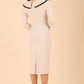 Model wearing diva catwalk Seed Elsye 3/4 Sleeve Knee Length Pencil Dress with Fold over bateau collar neckline with contrast piping and Bow feature on the left side of the bodice in Sandy Cream colour back