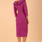 odel wearing diva catwalk Seed Elsye 3/4 Sleeve Knee Length Pencil Dress with Fold over bateau collar neckline with contrast piping and Bow feature on the left side of the bodice with decorative brooch in Dawn Purple colour back