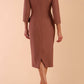 Model wearing diva catwalk Seed  Elsye 3/4 Sleeve Knee Length Pencil Dress with Fold over bateau collar neckline with contrast piping and Bow feature on the left side of the bodice with decorative brooch in Acorn Brown colour back