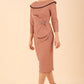 Model wearing diva catwalk Seed Elsye 3/4 Sleeve Knee Length Pencil Dress with Fold over bateau collar neckline with contrast piping and Bow feature on the left side of the bodice with decorative brooch in Acorn Brown colour front