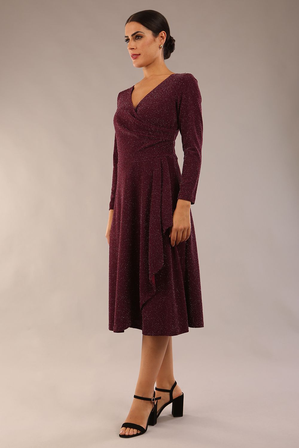 model is wearing diva catwalk westgate low v-neck wrapped swing skirt dress with long sleeves in burgundy sparkle colour front