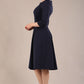 model is wearing a diva catwalk Cordelia Square Neck Pleated Midi A-line Dress with 3/4 sleeve in navy blue colour side