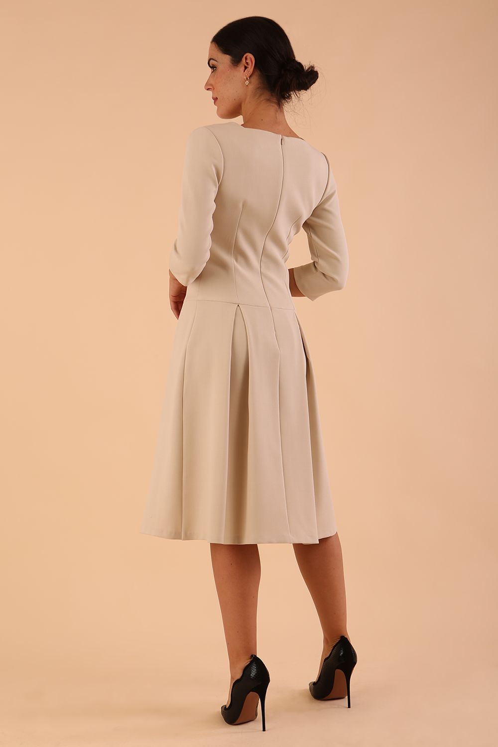 Model wearing diva catwalk Cordelia full skirt dress in cream colour