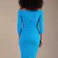 Model wearing diva catwalk Trixie dress against a beige background in (Turquoise)