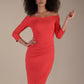 Model wearing diva catwalk Trixie dress against a beige background in (Salmon Red)