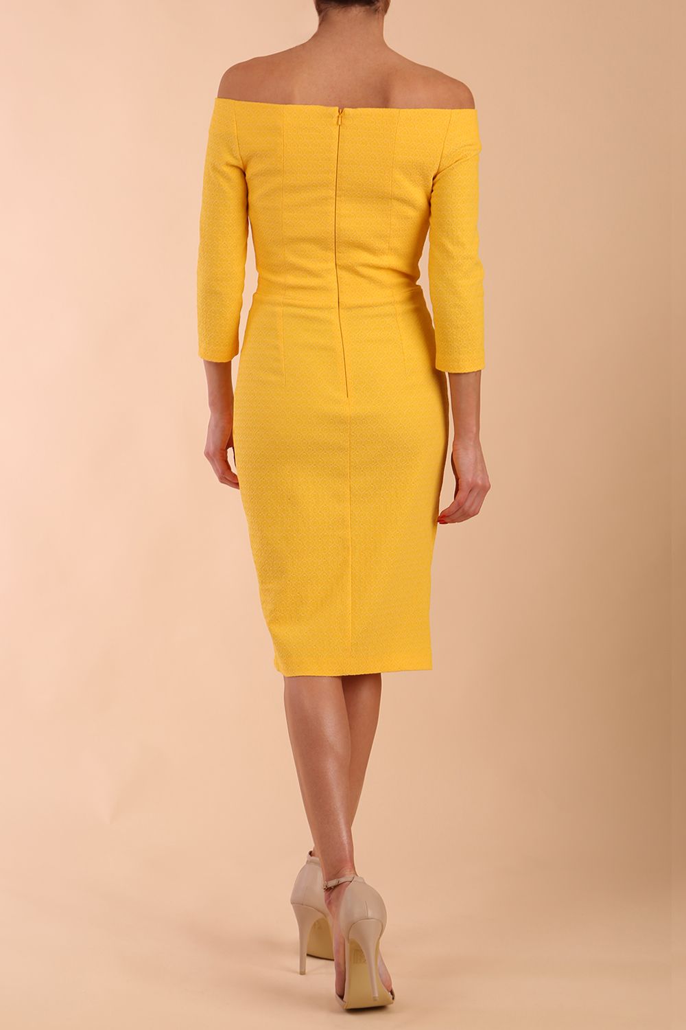 Model wearing diva catwalk Trixie dress in Sunrise Yellow back