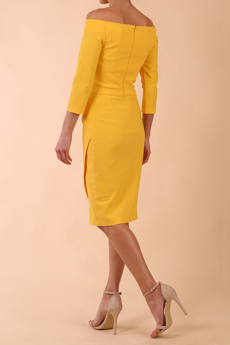 Model wearing diva catwalk Trixie dress in Sunrise Yellow back