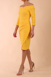 Model wearing diva catwalk Trixie dress in Sunrise Yellow side