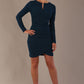 model wearing a diva catwalk lydia long sleeved pleated Mini Dress from Diva Catwalk in Teal in high heal shoes against a beige background