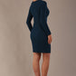 model wearing a diva catwalk lydia long sleeved pleated Mini Dress from Diva Catwalk in Teal in high heal shoes against a beige background back view