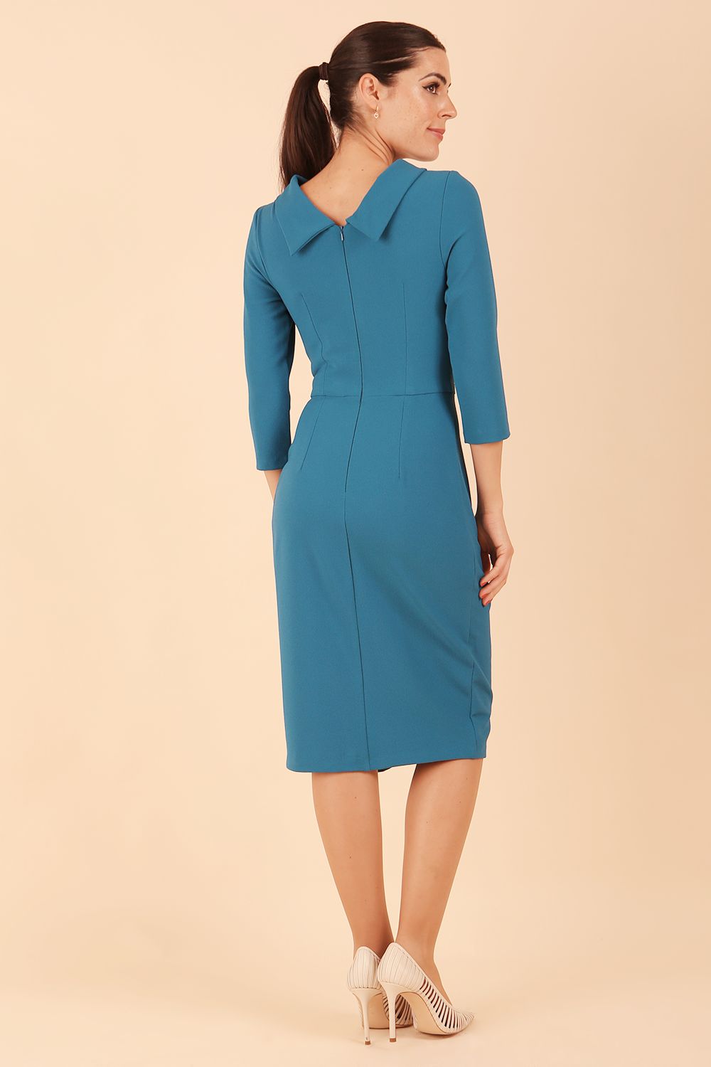 Model wearing diva catwalk Hazel pencil skirt dress with 3/4 sleeved in Tropical Teal back