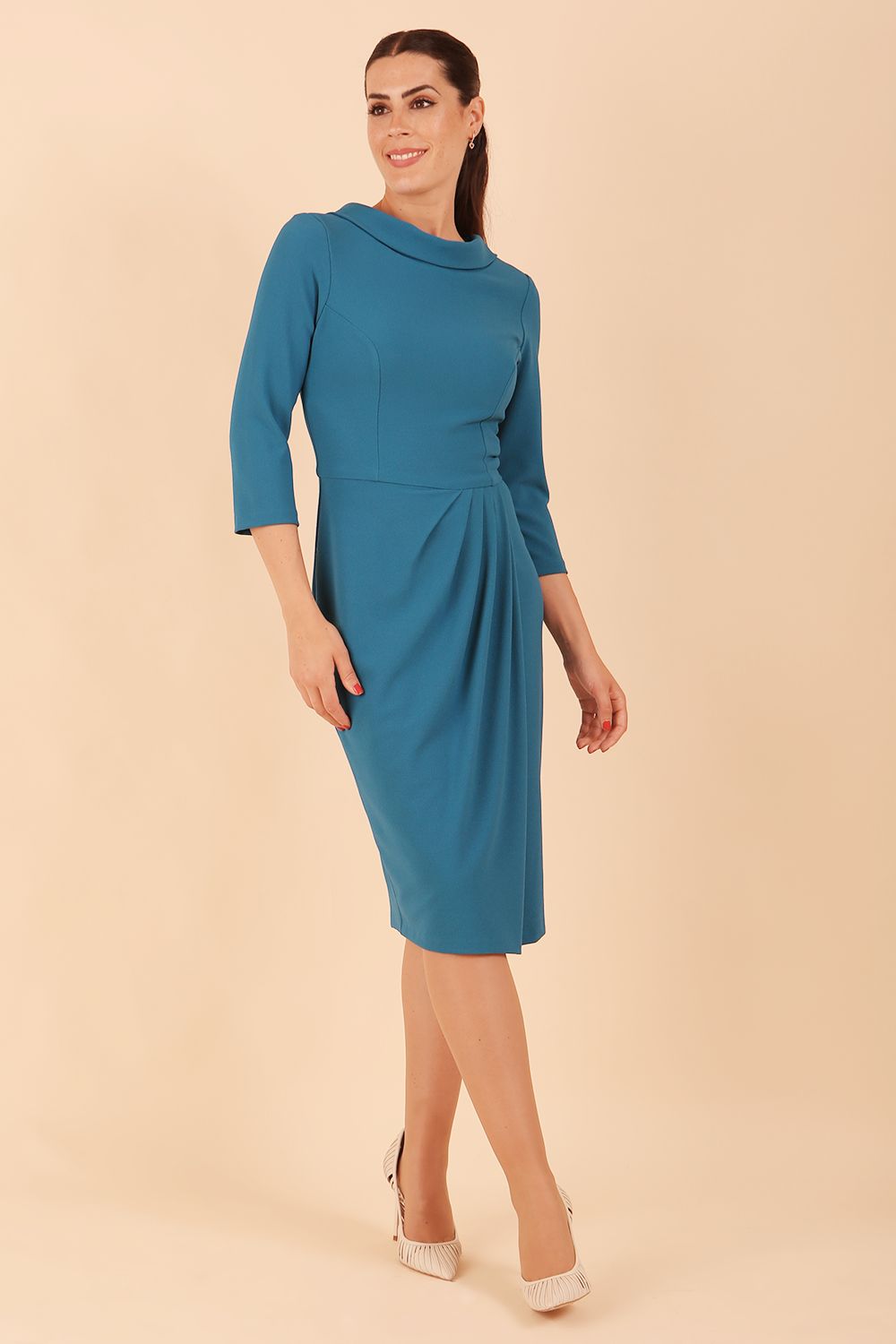 Model wearing diva catwalk Hazel pencil skirt dress with 3/4 sleeved in Tropical Teal side