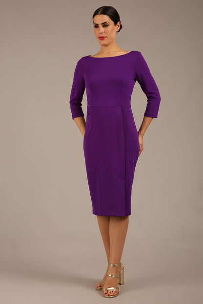 brunette Model wearing a diva catwalk Kinga 3/4 Sleeve pencil skirt dress with round neckline in Passion Purple colour front 