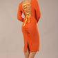 brunette model is wearing a diva catwalk Zoey Sleeved Pencil Dress ribbon back with long sleeves and rushed details front and back in Amber Orange colour back image