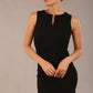 Brunette model is wearing a diva catwalk Lydia Sleeveless Mini Dress round neckline wrap style in black colour front  image with sunglasses
