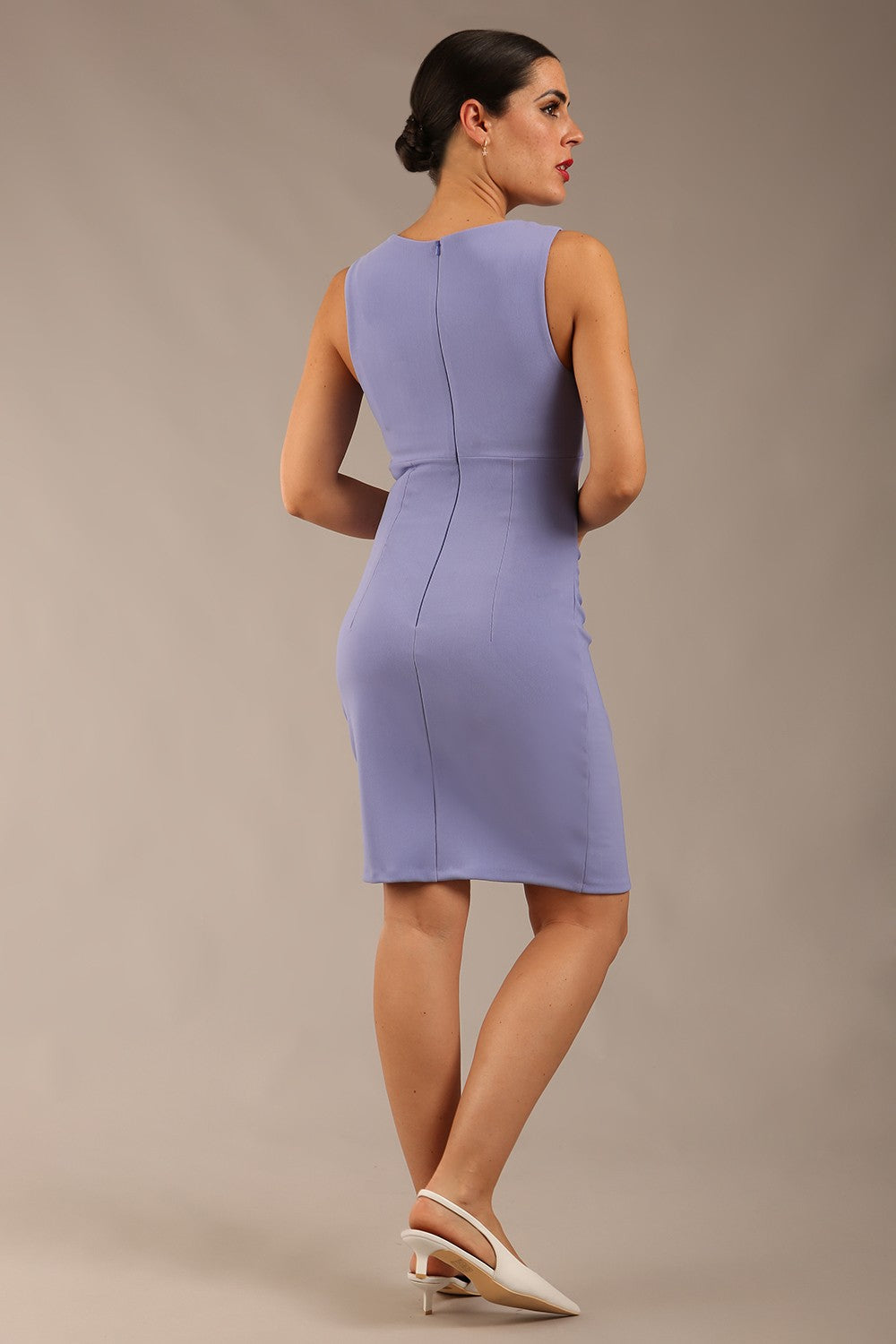Brunette model is wearing a diva catwalk Lydia Sleeveless Mini Dress round neckline wrap style in vista blue colour back image 