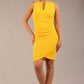 Brunette model is wearing a diva catwalk Lydia Sleeveless Mini Dress round neckline wrap style in sunshine yellow colour front image