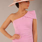 A Brunette Model is wearing a diva catwalk Phoebe One Shoulder Pencil Dress in knee length side vent - dawn pink front with a hat