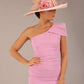 A Brunette Model is wearing a diva catwalk Phoebe One Shoulder Pencil Dress in knee length side vent - dawn pink front with a hat