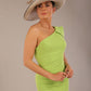A Brunette Model is wearing a diva catwalk Phoebe One Shoulder Pencil Dress in knee length side vent with a hat - Lime green front