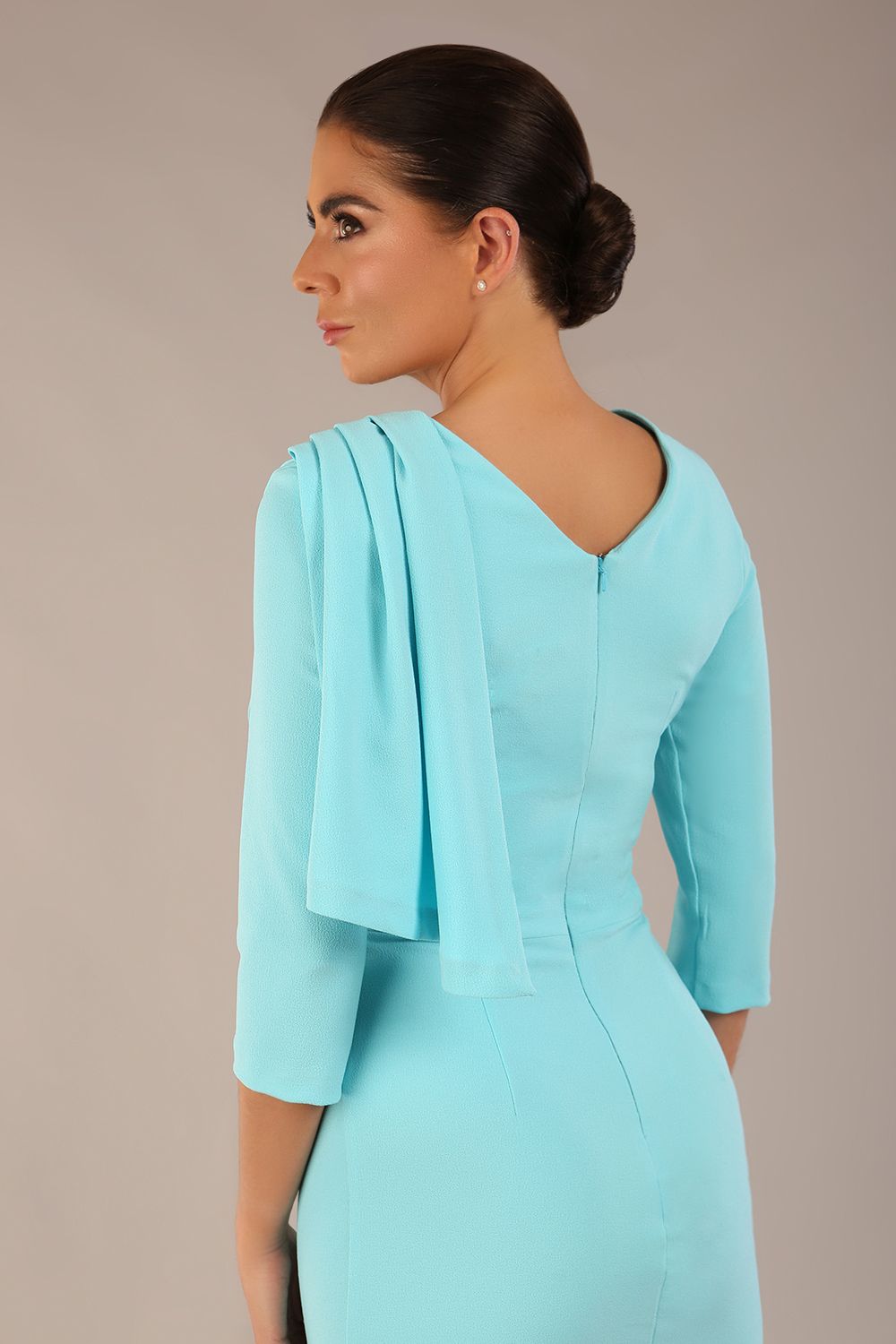 brunette model is wearing a diva catwalk Frieth Gathered Shoulder Dress 3/4 sleeves knee length with shoulder detail in turquoise colour back image