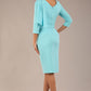 brunette model is wearing a diva catwalk Frieth Gathered Shoulder Dress 3/4 sleeves knee length with shoulder detail in turquoise colour back image