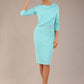 brunette model is wearing a diva catwalk Frieth Gathered Shoulder Dress 3/4 sleeves knee length with shoulder detail in turquoise colour front image with a hat