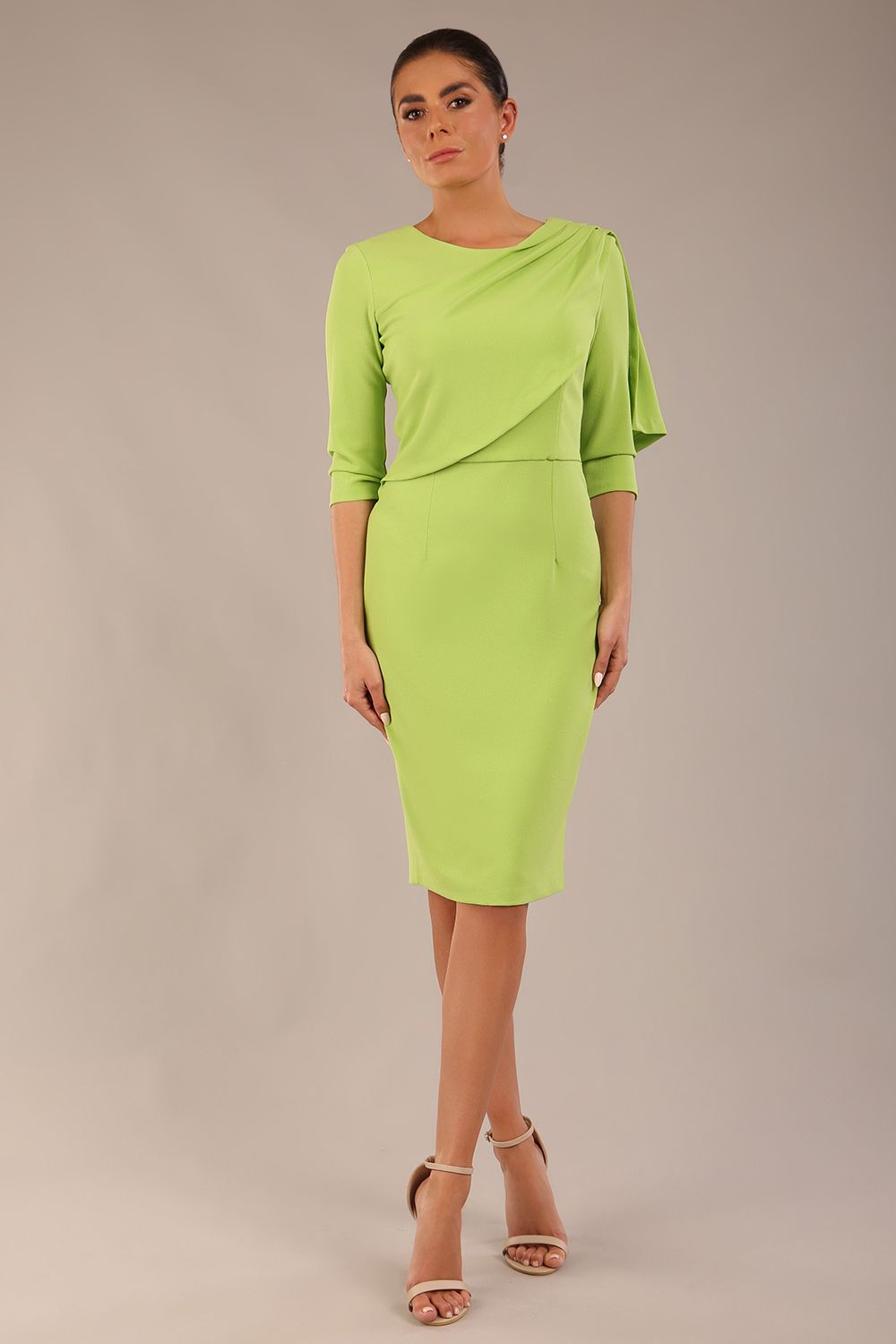 brunette model is wearing a diva catwalk Frieth Gathered Shoulder Dress 3/4 sleeves knee length with shoulder detail in paradise green colour front image