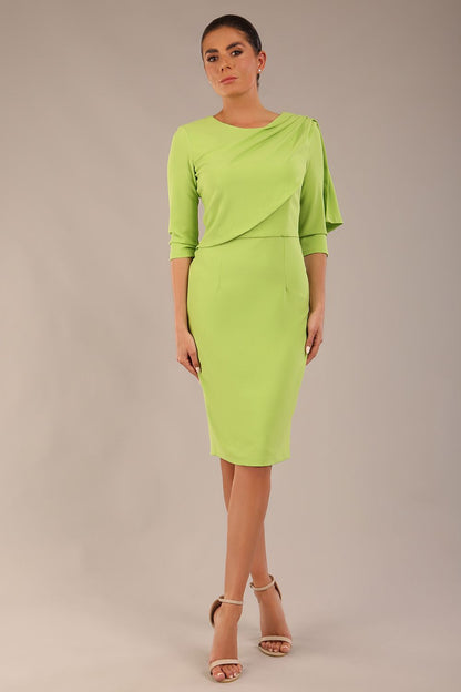 brunette model is wearing a diva catwalk Frieth Gathered Shoulder Dress 3/4 sleeves knee length with shoulder detail in paradise green colour front image
