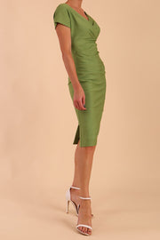 Model is wearing Brooke Cap Sleeve Pencil Dress in Couture Stretch Fabric with V Neckline and Hip Pleating in Acid Green front side