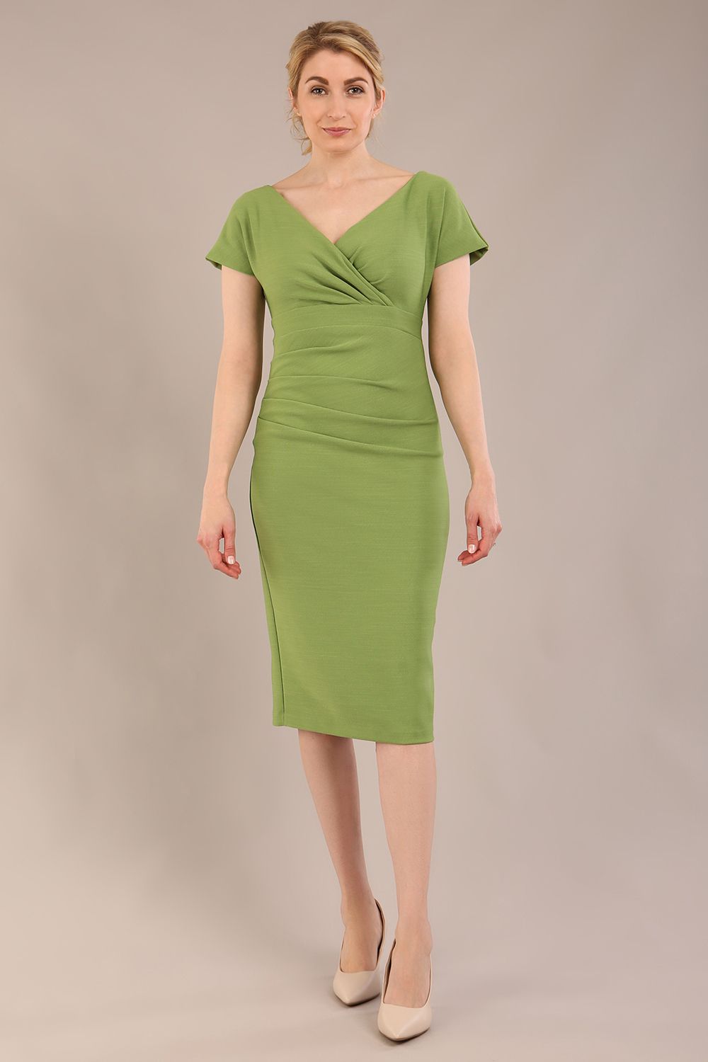 Model is wearing Brooke Cap Sleeve Pencil Dress in Couture Stretch Fabric with V Neckline and Hip Pleating in Citrus green front