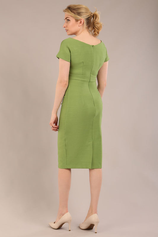 Model is wearing Brooke Cap Sleeve Pencil Dress in Couture Stretch Fabric with V Neckline and Hip Pleating in Citrus green back