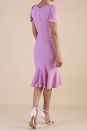Model wearing diva catwalk Seraphina Fishtail skirt dress in Dawn Pink back