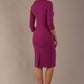 The model is wearing a diva catwalk Juliette 3/4 Sleeve Knee Length dress with bow detail in hollyhock purple colour against a plain background back view