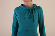 Detail Model wearing diva catwalk Juliette 3/4 Sleeve Knee Length Pencil dress Bow collar neckline in Parasailing Green side