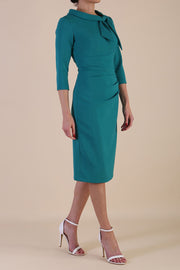 Model wearing diva catwalk Juliette 3/4 Sleeve Knee Length Pencil dress in Parasailing Green side