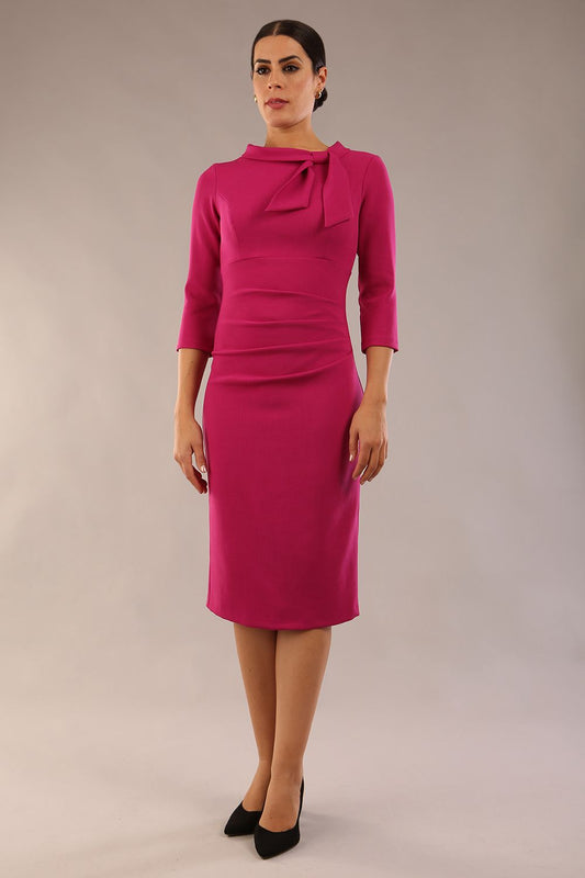 Model is wearing a diva catwalk Juliette 3/4 Sleeve Knee Length dress with bow detail in magenta front