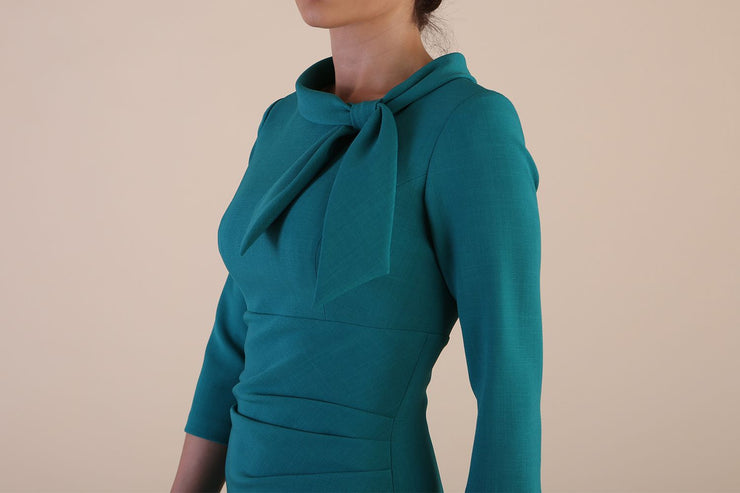 Detail Model wearing diva catwalk Juliette 3/4 Sleeve Knee Length Pencil dress Bow collar neckline in Parasailing Green side