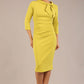 Model is wearing a diva catwalk Juliette 3/4 Sleeve Knee Length dress with bow detail in citrus green colour