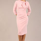 Model is wearing a diva catwalk Juliette 3/4 Sleeve Knee Length dress with bow detail in crystal pink colour