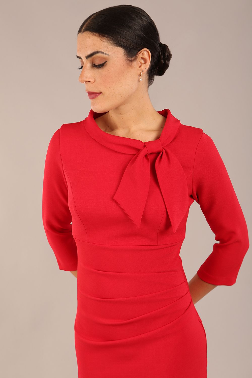 Model is wearing a diva catwalk Juliette 3/4 Sleeve Knee Length dress with bow detail in scarlet red colour