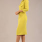 Model is wearing a diva catwalk Juliette 3/4 Sleeve Knee Length dress with bow detail in citrus green colour