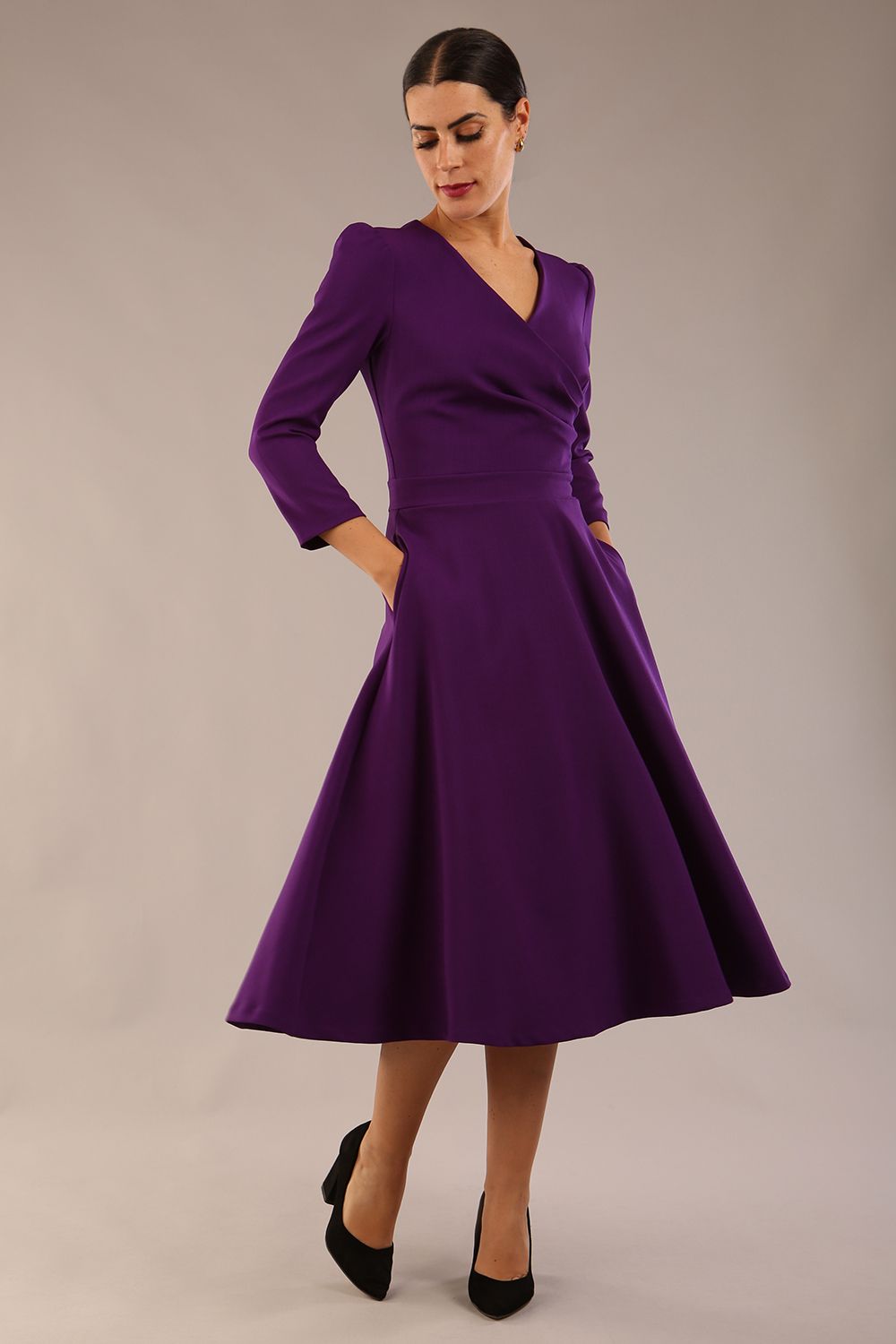 Model wearing diva catwalk Kate 3/4 Length Sleeve A-Line Swing Dress with pockets in Deep Purple front